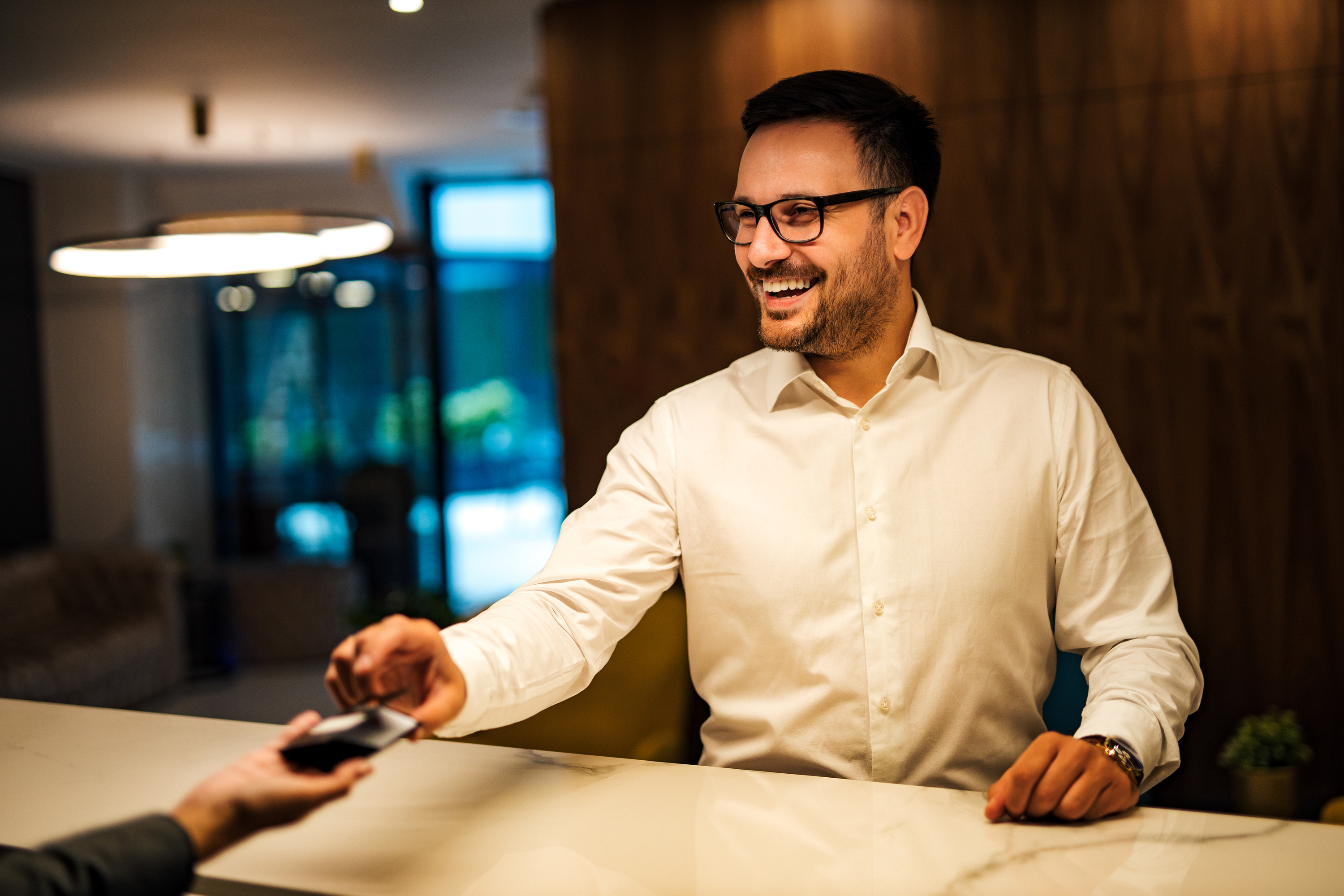 portrait-of-a-smiling-man-ringing-a-bell-at-hotel-2024-10-18-06-33-59-utc-1